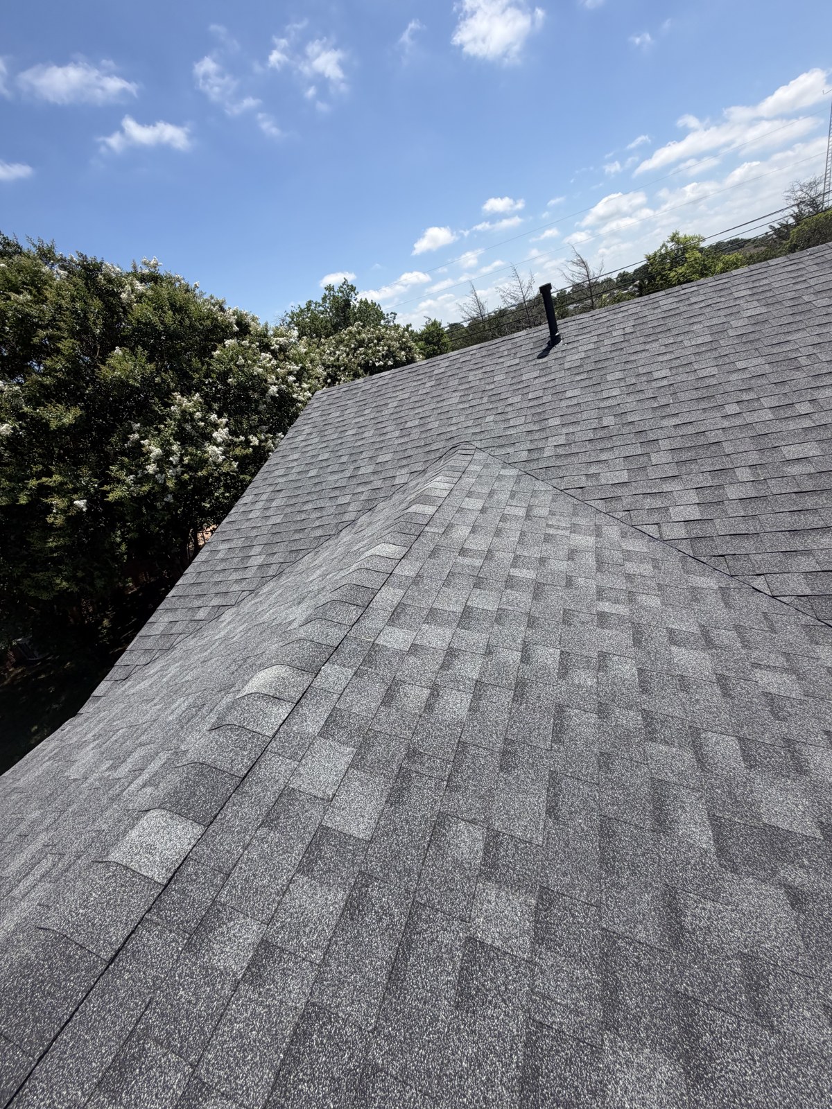 Close-up of new shingle roof installation