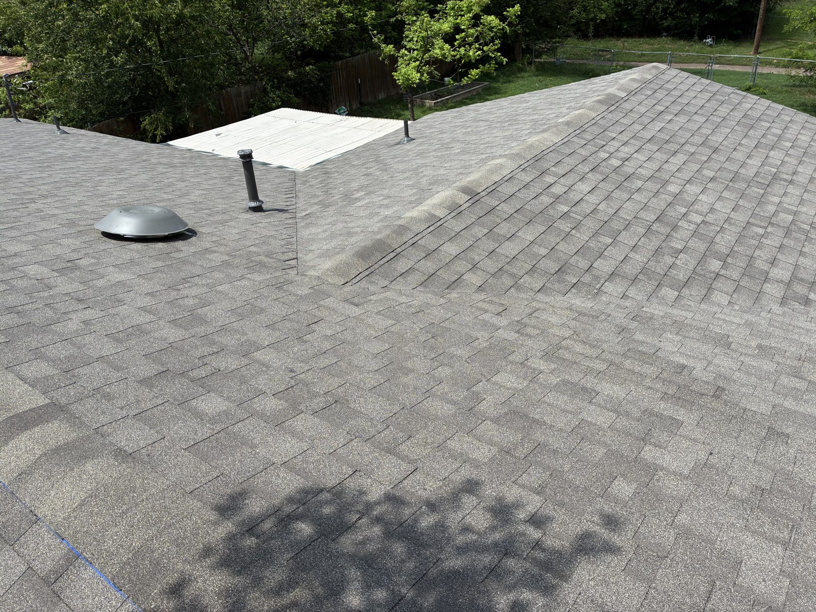 Close-up inspection of shingle roof repair area